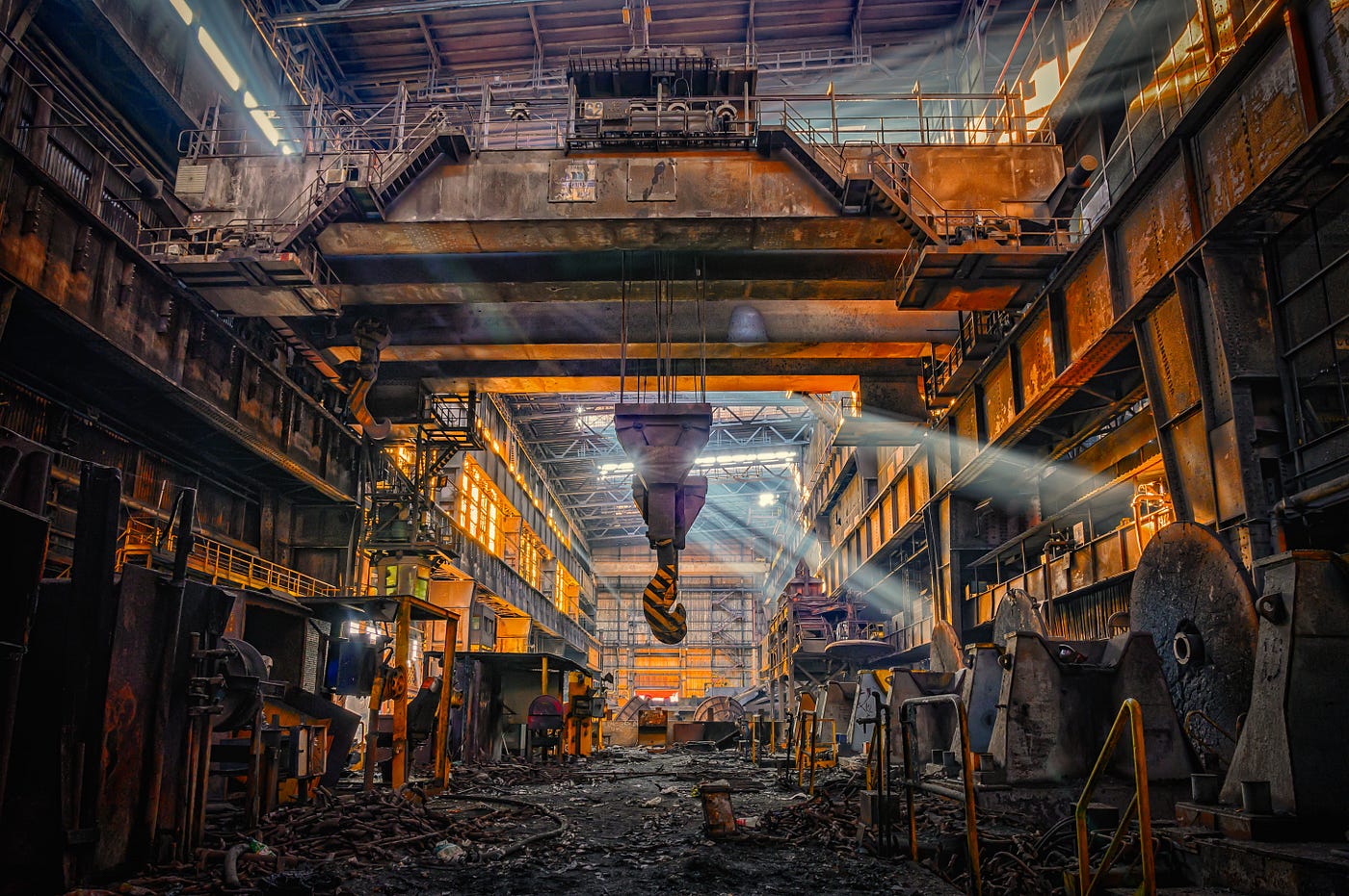 The inside of a steel mill looking all dramatic. The Only Singleton by Jim Latham | Photo by Peter Herrmann on Unsplash