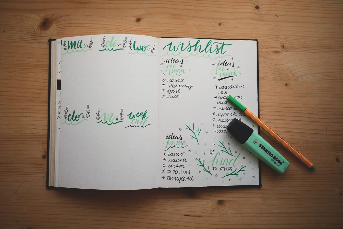A notebook open that has some handwriting in it, the pages having green colored text on it, there is a pencil and highlighter sitting on the viewer’s right of the page