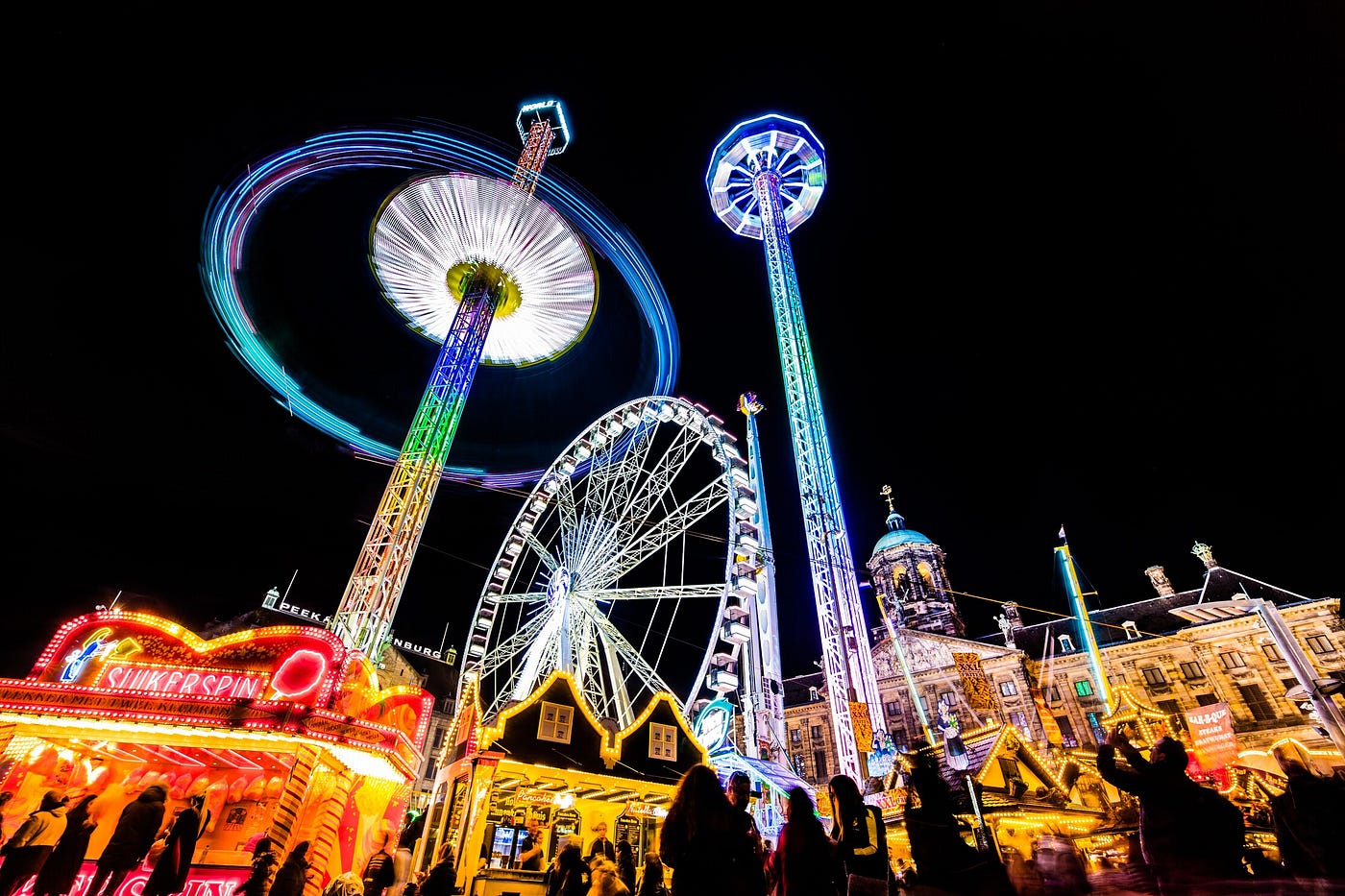 Ferris wheel and other city buildings lit up at night