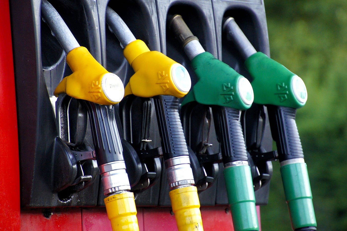image of four gasoline pump handles