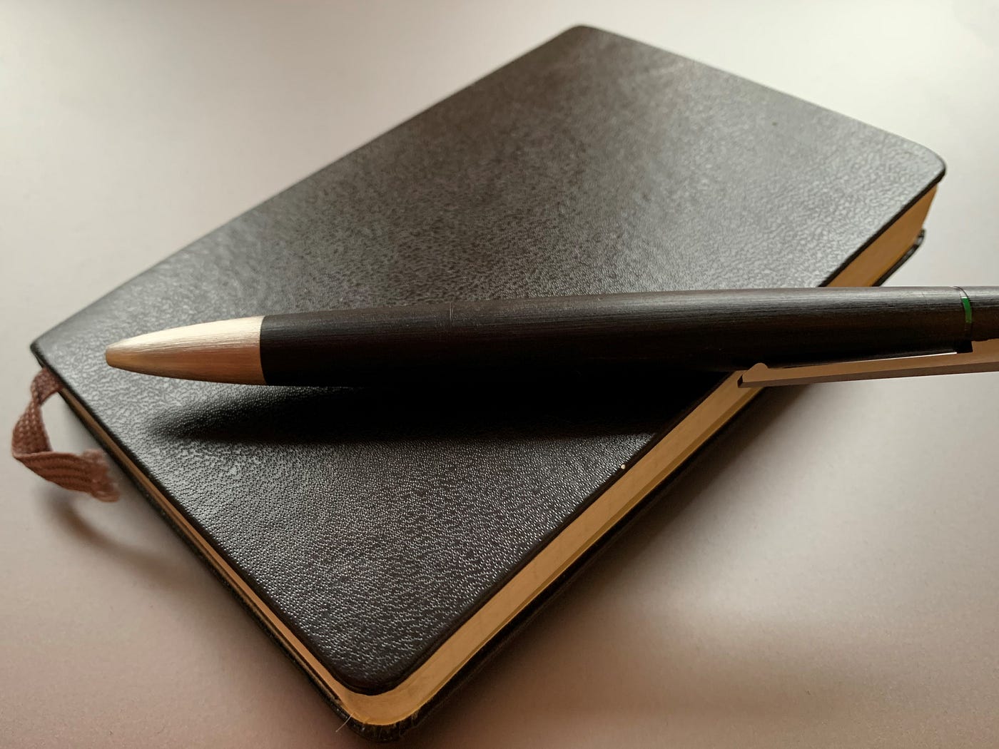 A paper notebook and a pen