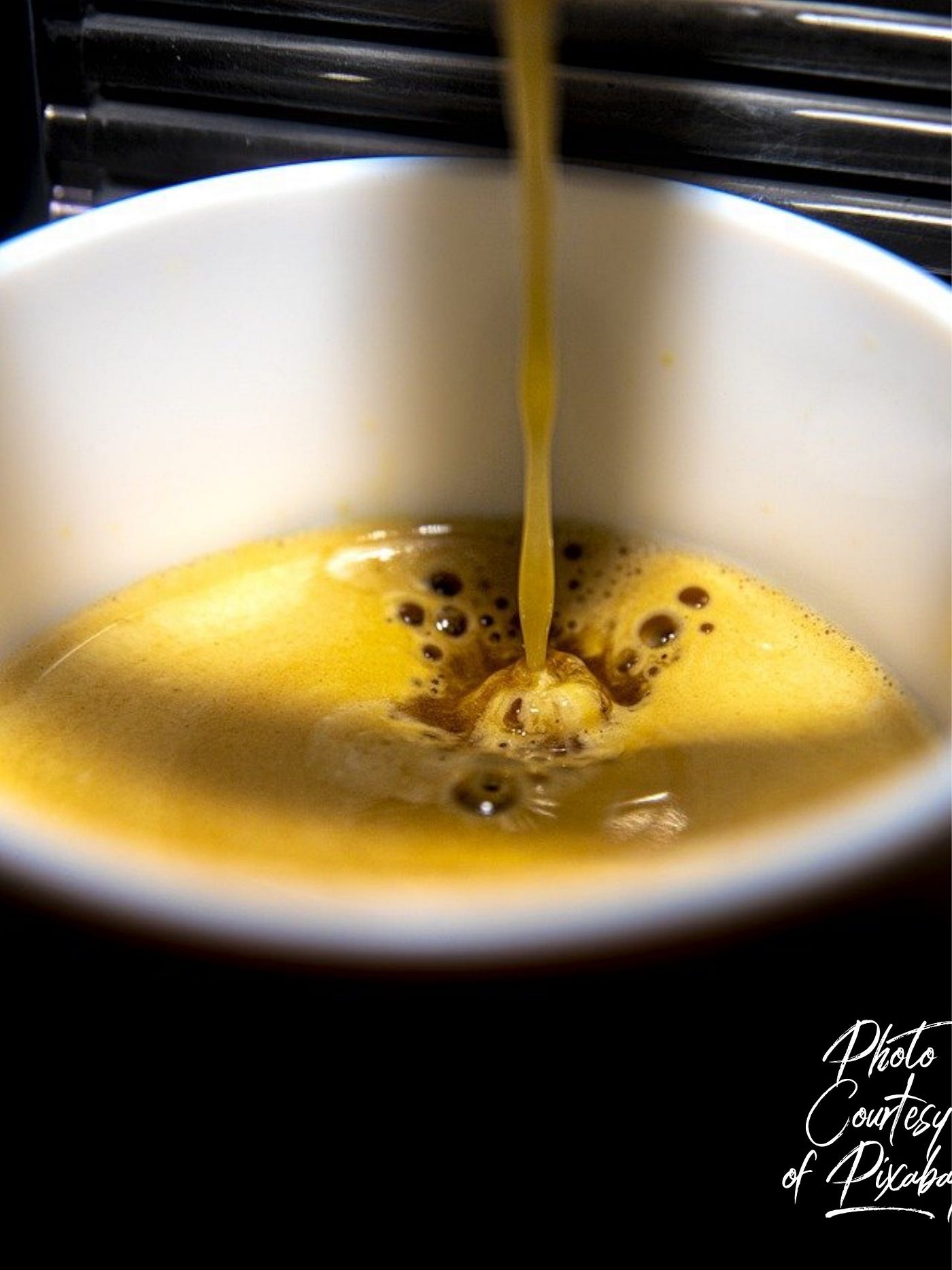 Color photo of coffee dripping into a white mug or coffee cup.