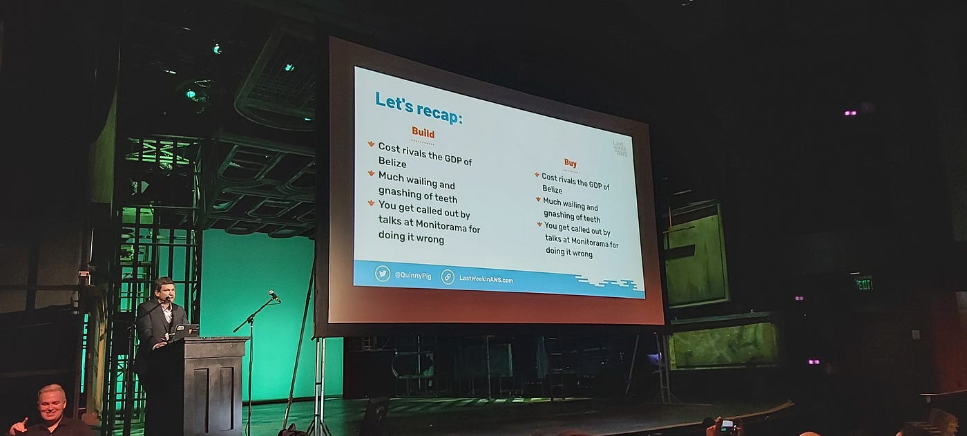 A photograph of a slide from a presentation — the slide is split into “build” on one side and “buy” on the other. The content on both sides is the same.