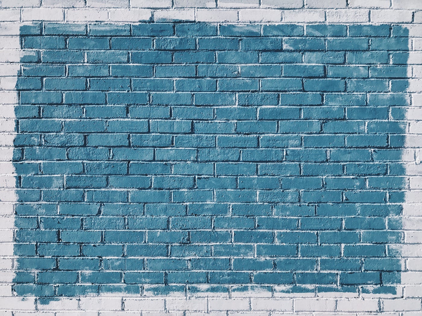 a brick wall with a rectangle painted a different color