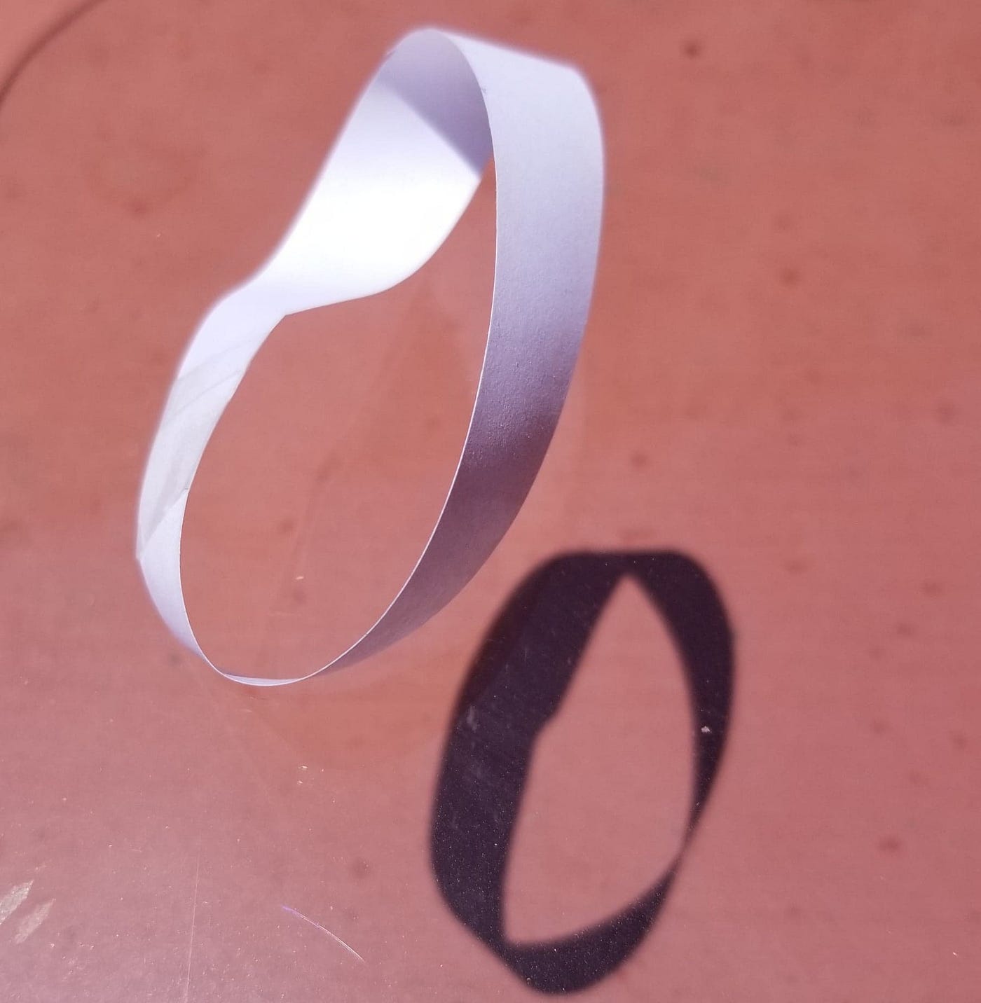Moebius strip projecting a shadow