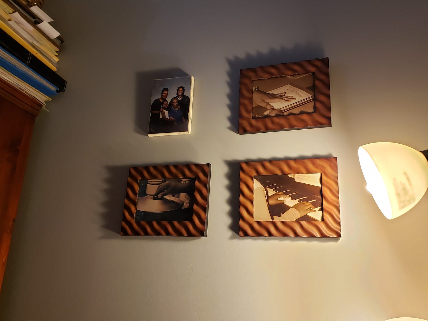 Family portraits hanging on the wall with dim lighting.