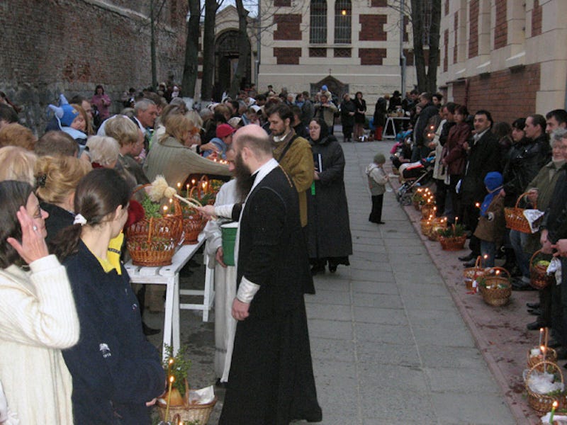 Ukrainian priest blessing Easter eggs