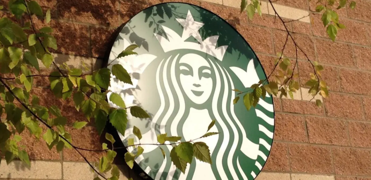 Starbucks logo against a brick wall