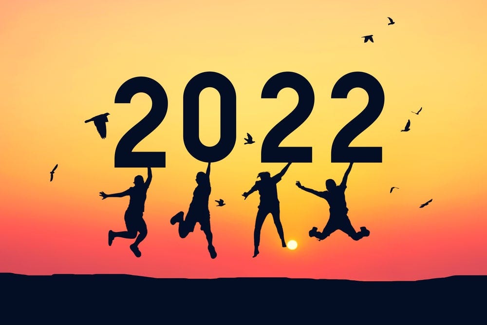 Four figures leaping for joy under the number 2022.
