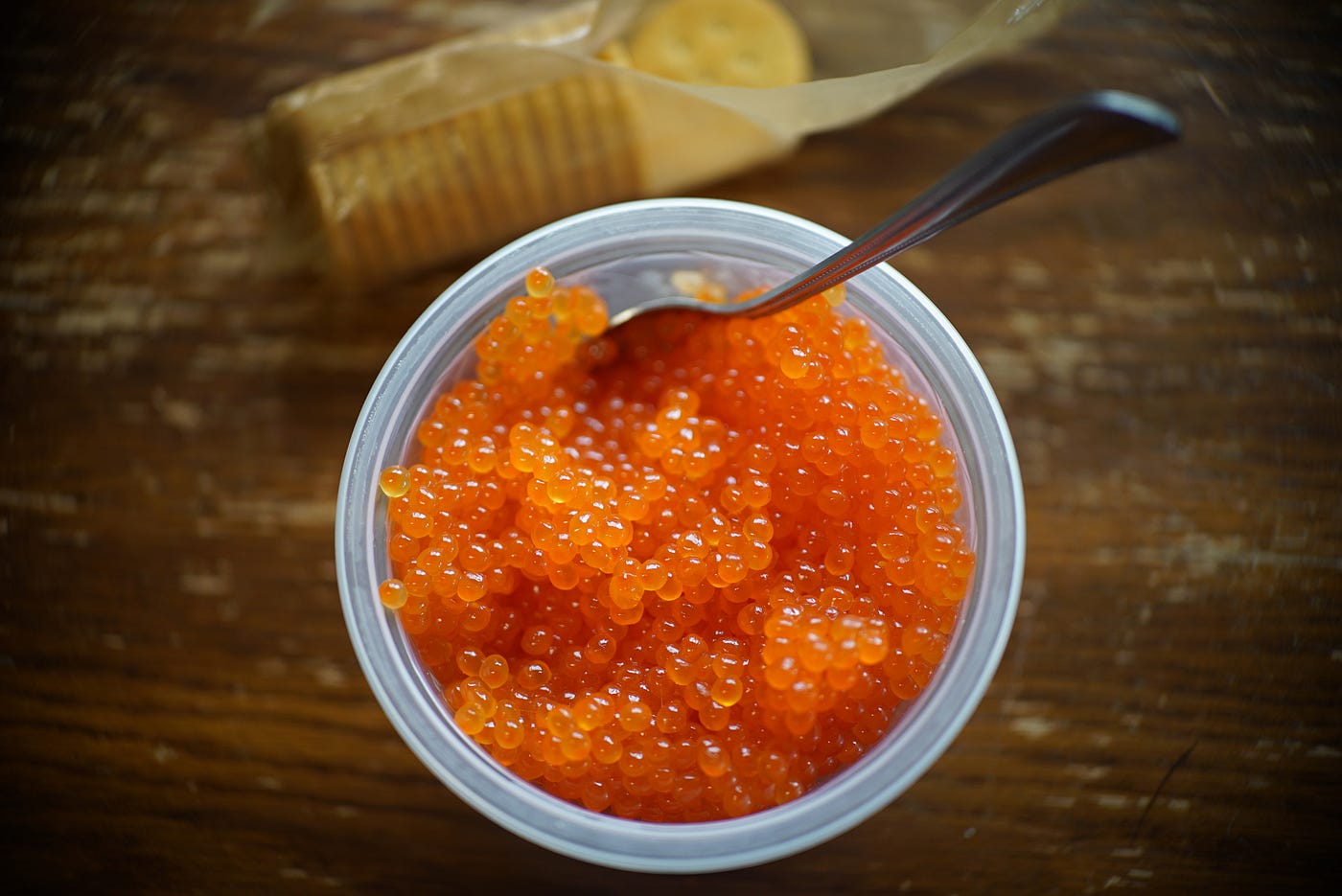 orange eggs in a bowl by crackers
