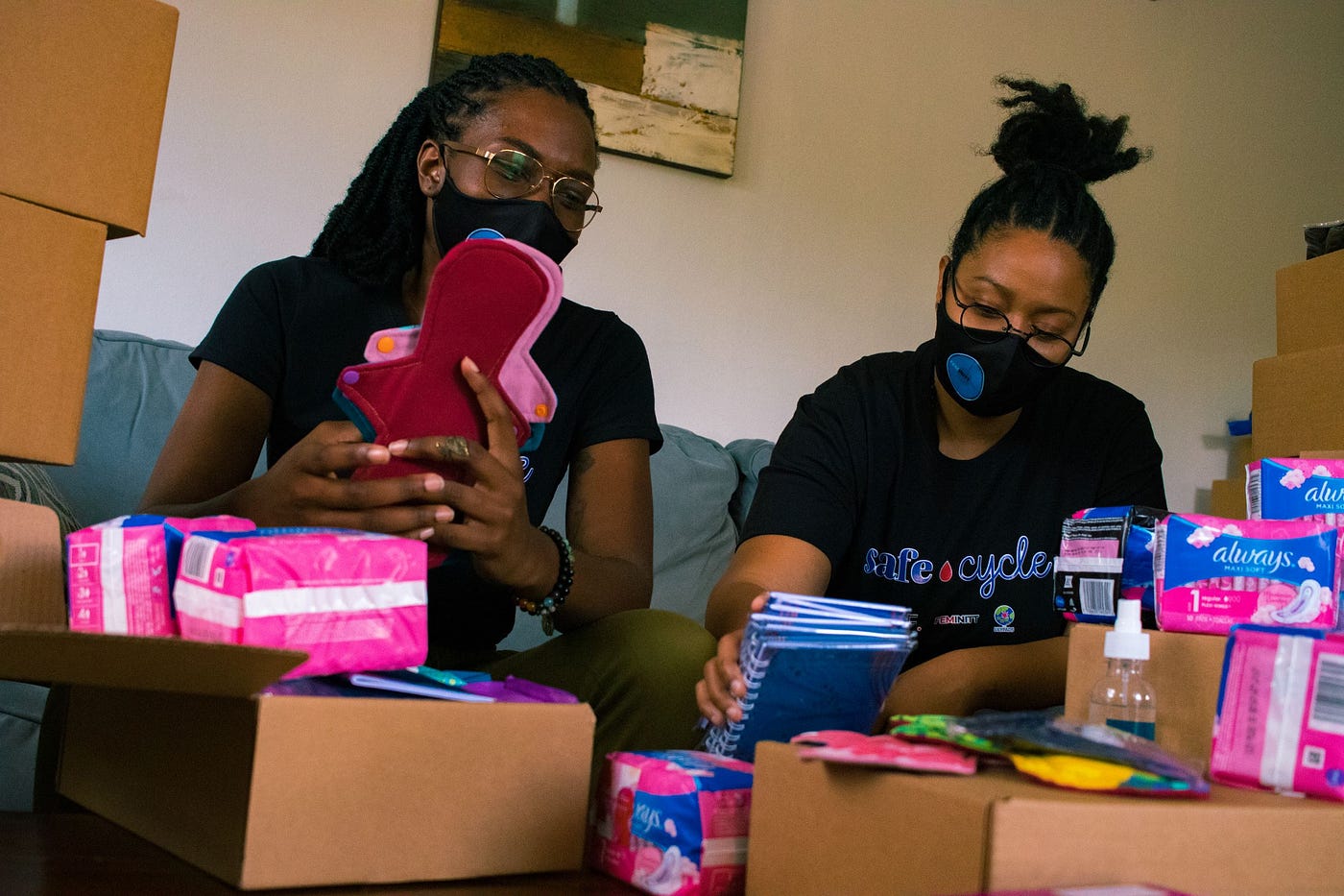 Ashlee Burnett and a colleague preparing period kits for people who menstruate in Trinidad and Tobago.
