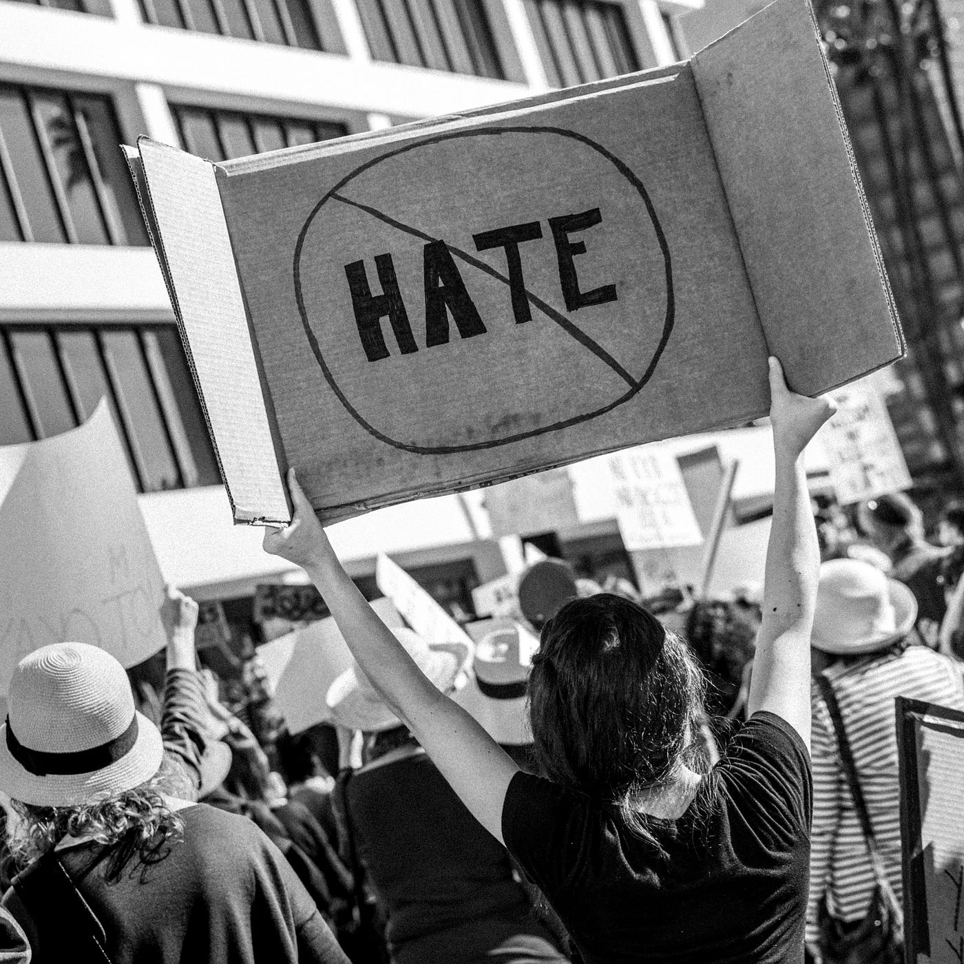 A woman protesting hate at a rally