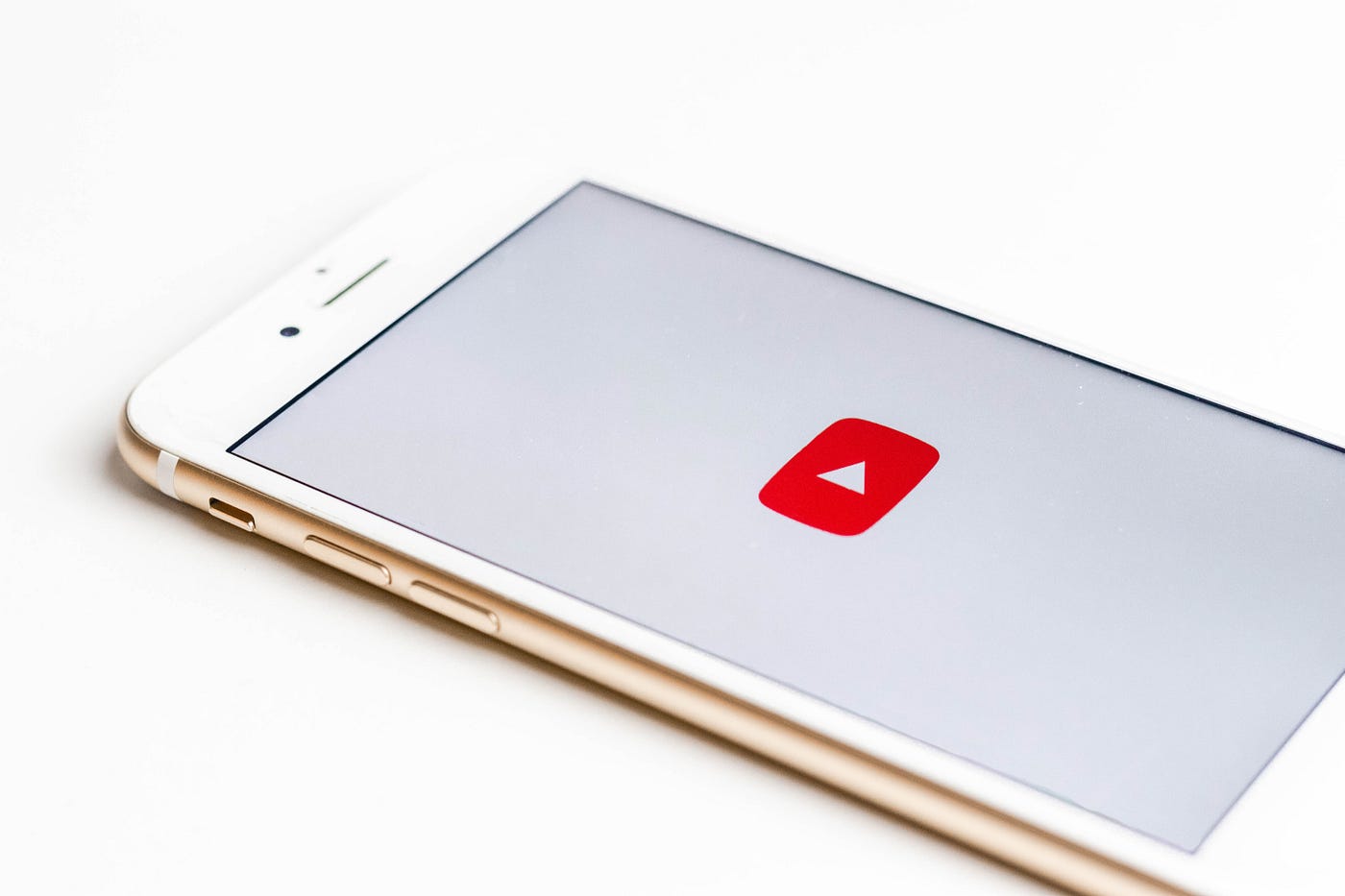 An image of a phone with the YouTube loading screen displayed.