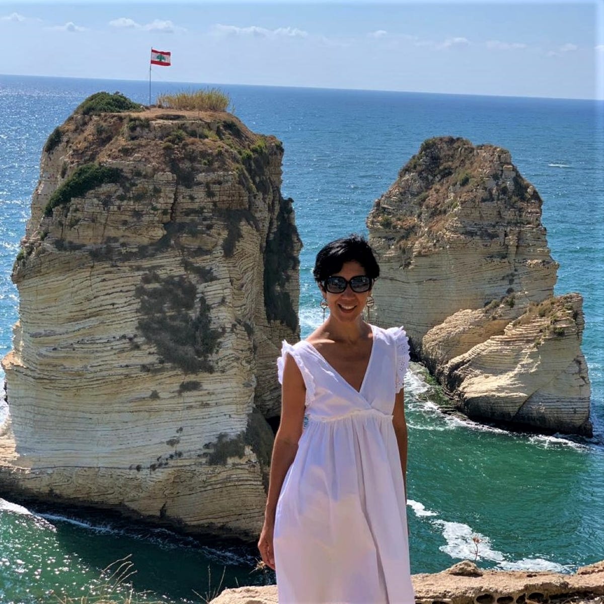 Raouché Rocks, Beirut, woman posing wearing sunglasses and a white dress