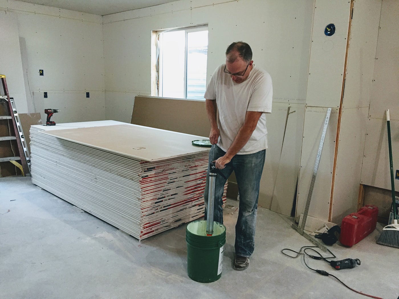 Drywalling the studio’s outer wall — using double 5/8" drywall and