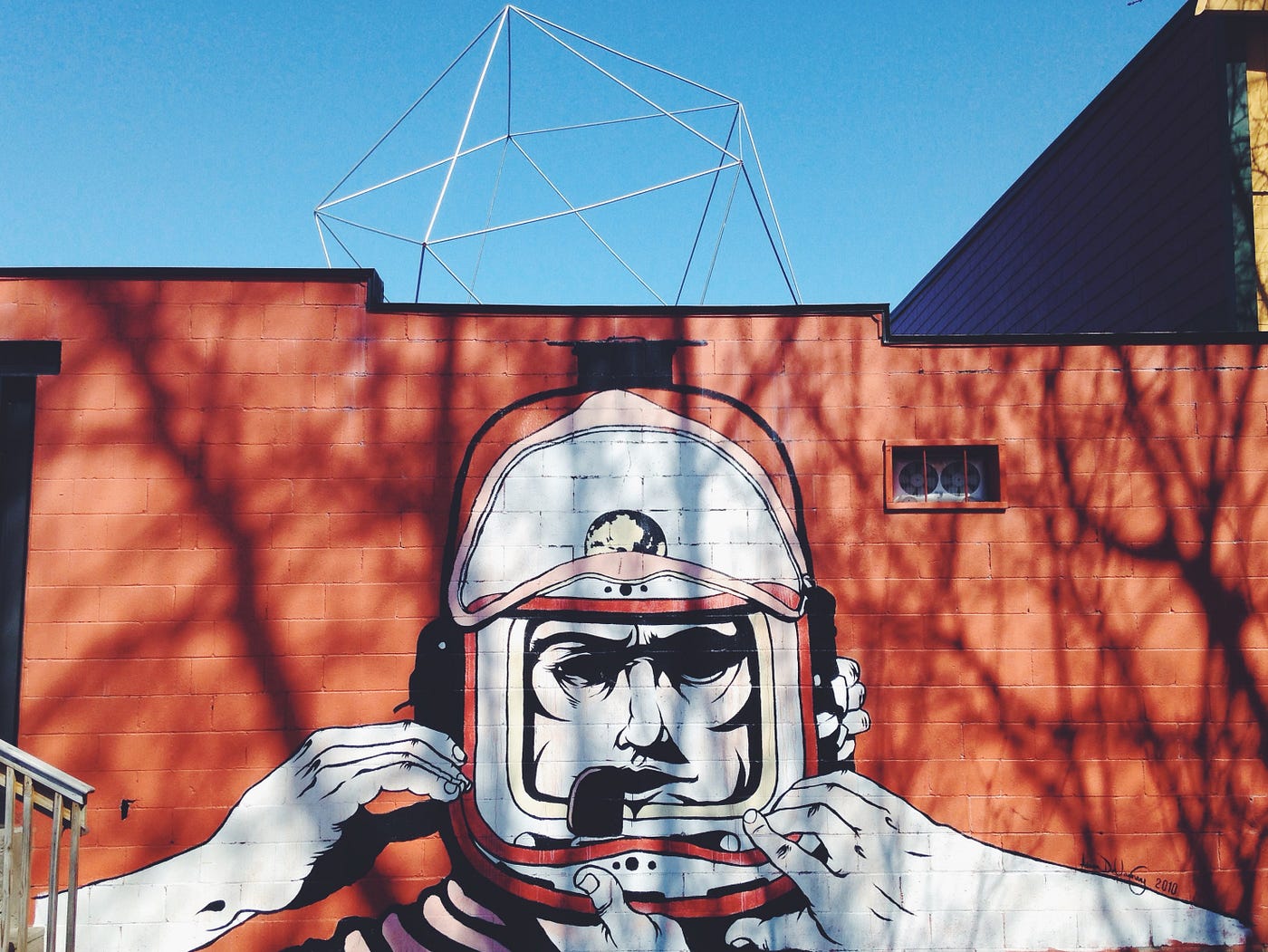 graffiti of a spaceman’s head on a red background