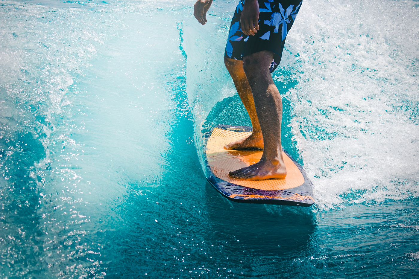 A close-up photo of a man surfing in shorts
