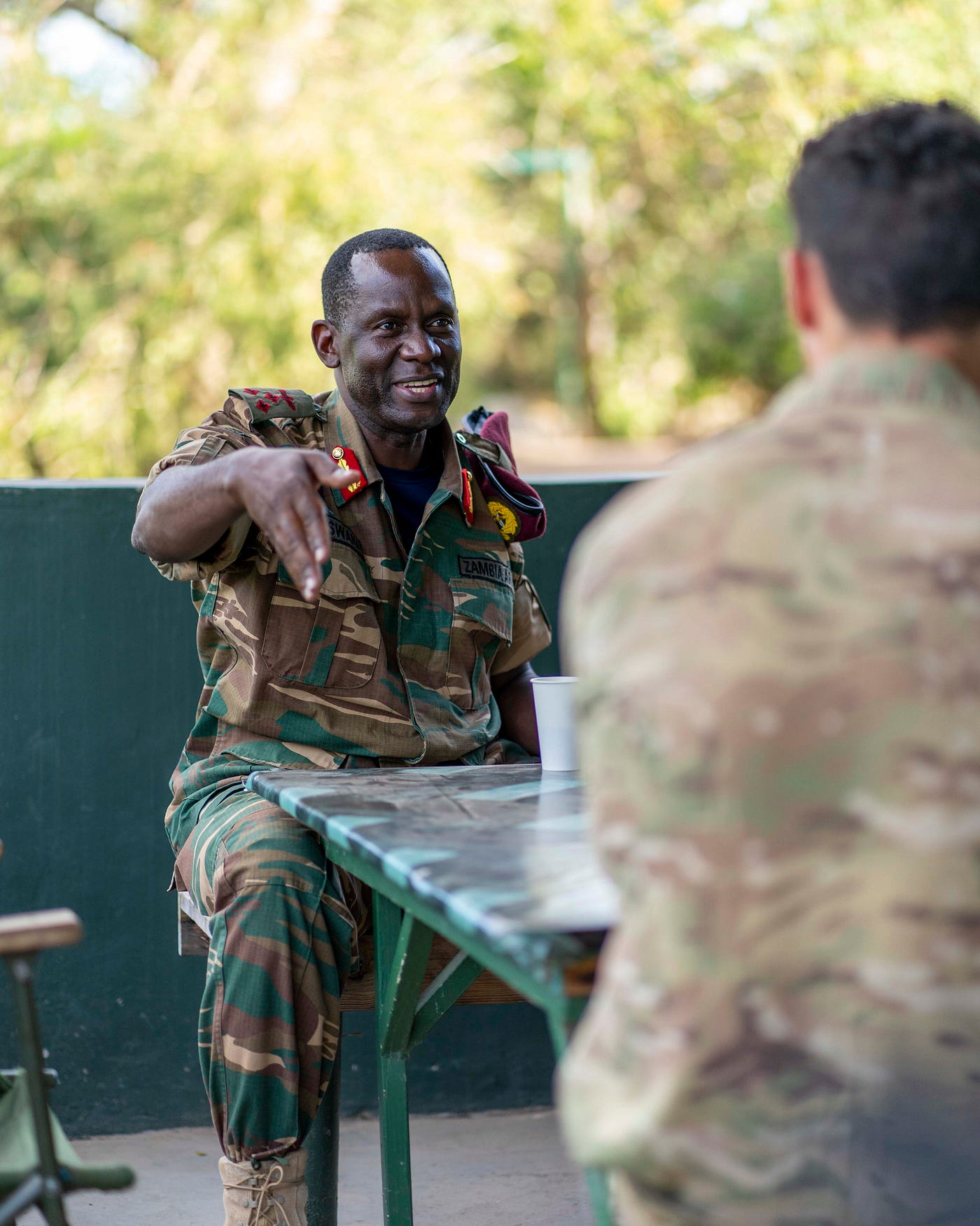 Zambian officer talking to UK Armed Forces