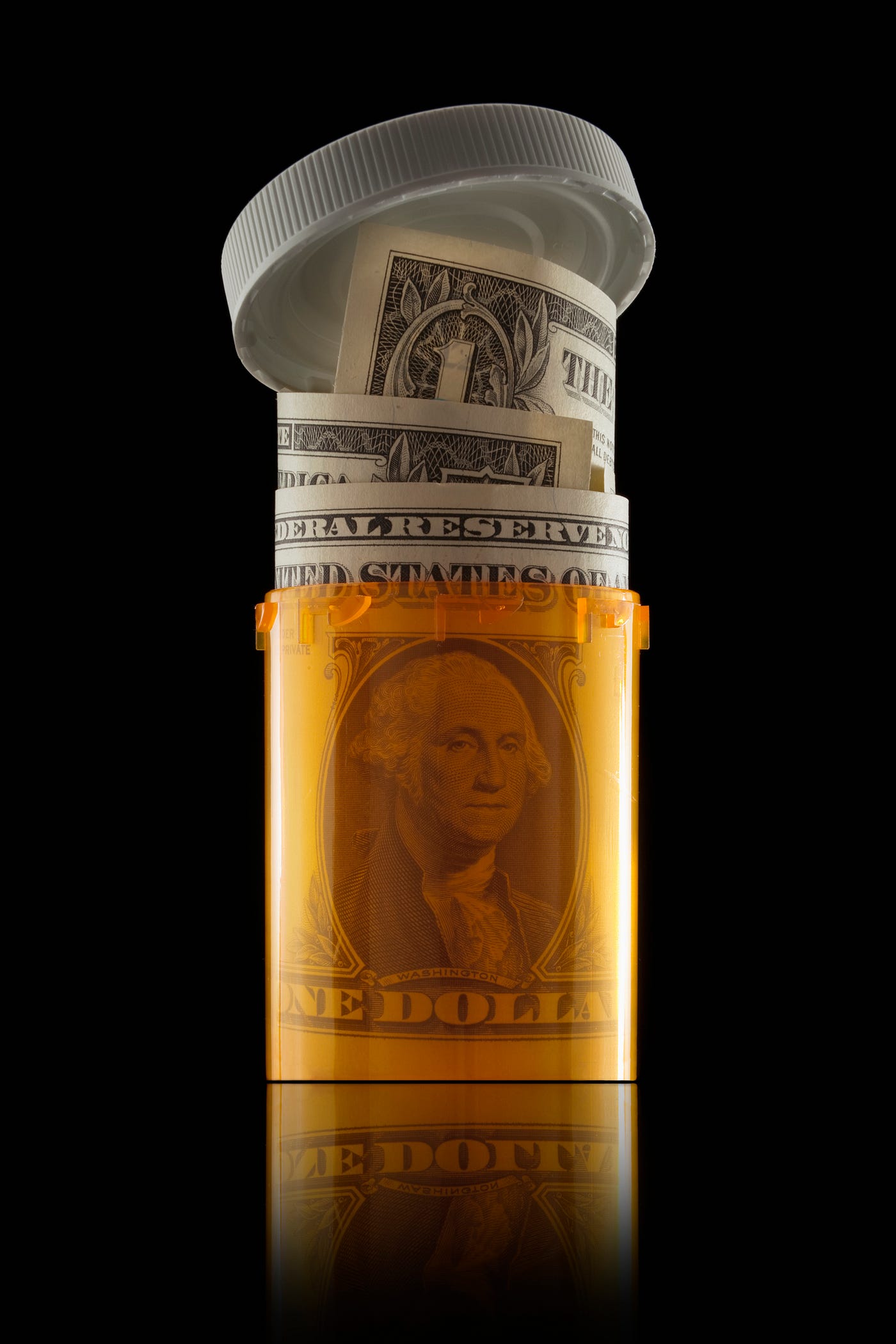 A US dollar bill rolled up in a prescription bottle.