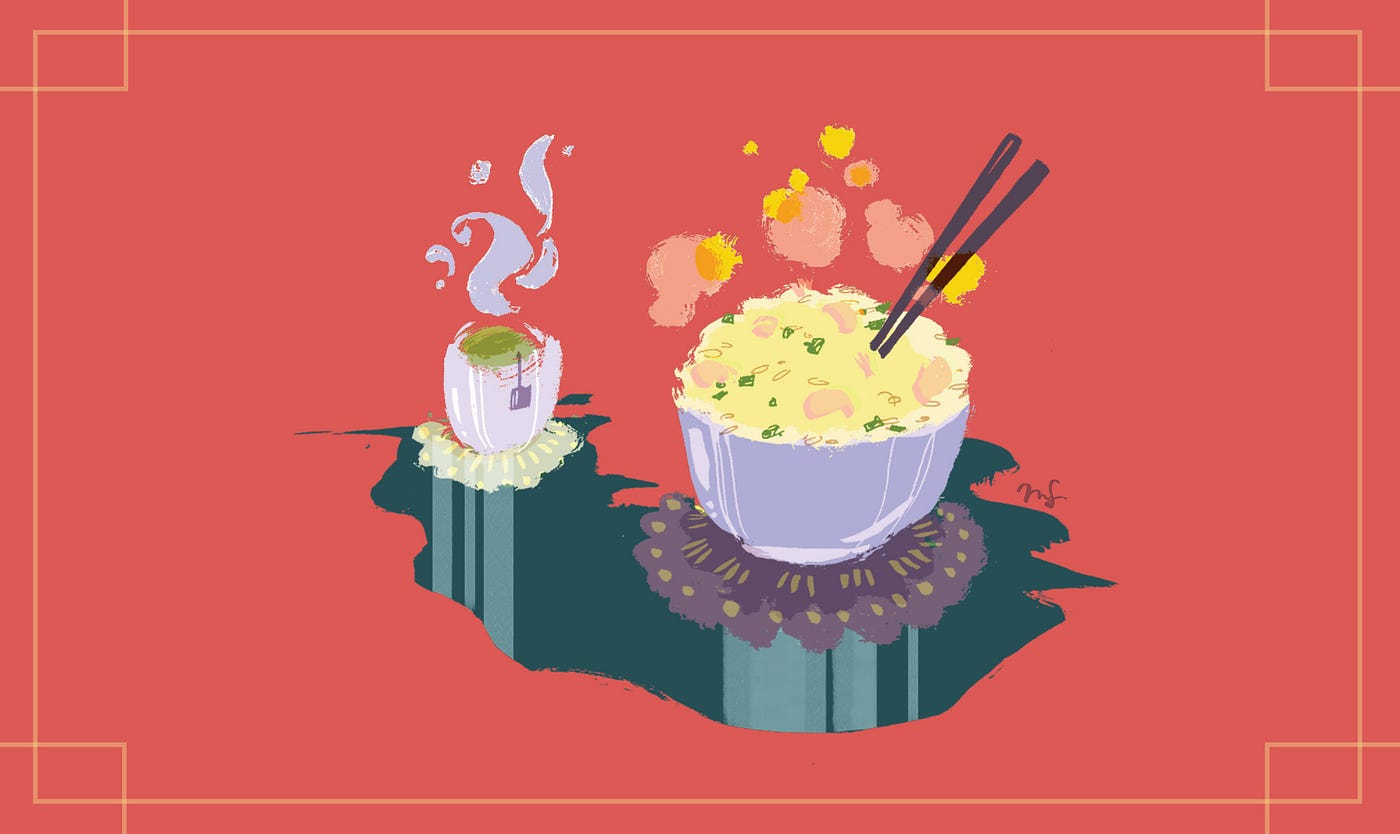 A bowl of steaming fried rice with a cup of hot green tea.