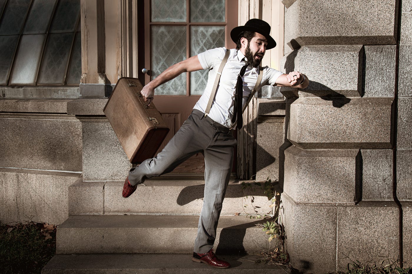 Person running out door, looking at watch, and carrying a briefcase