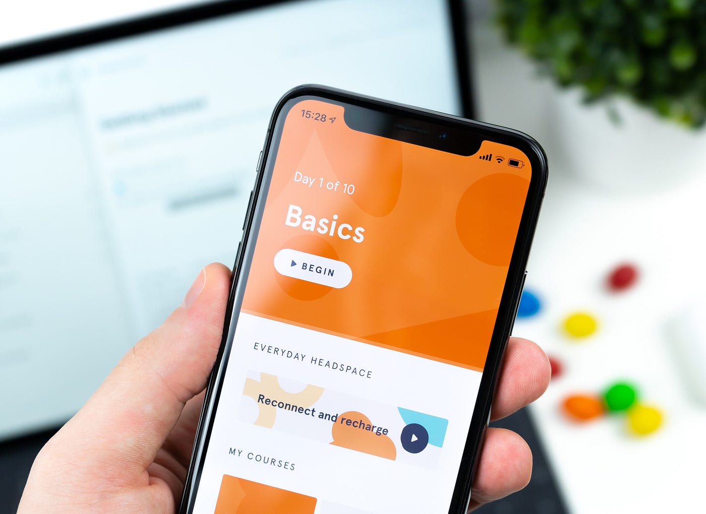 A person holds a phone with the Headspace app opened up.