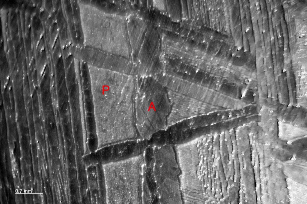 Widmanstatten structure of Kamicite in the Muonionalusta meteorite. P is the Plessite structure. A is a Kamacite lamellla in the cutting plane.