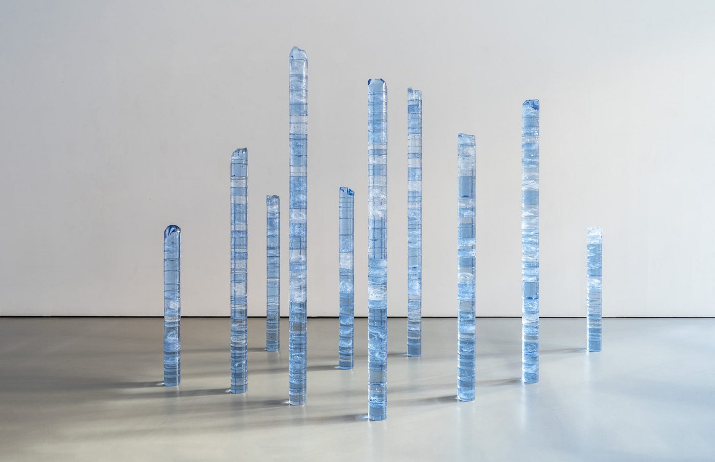 Ten columns of pale blue glass of diffrent heights.