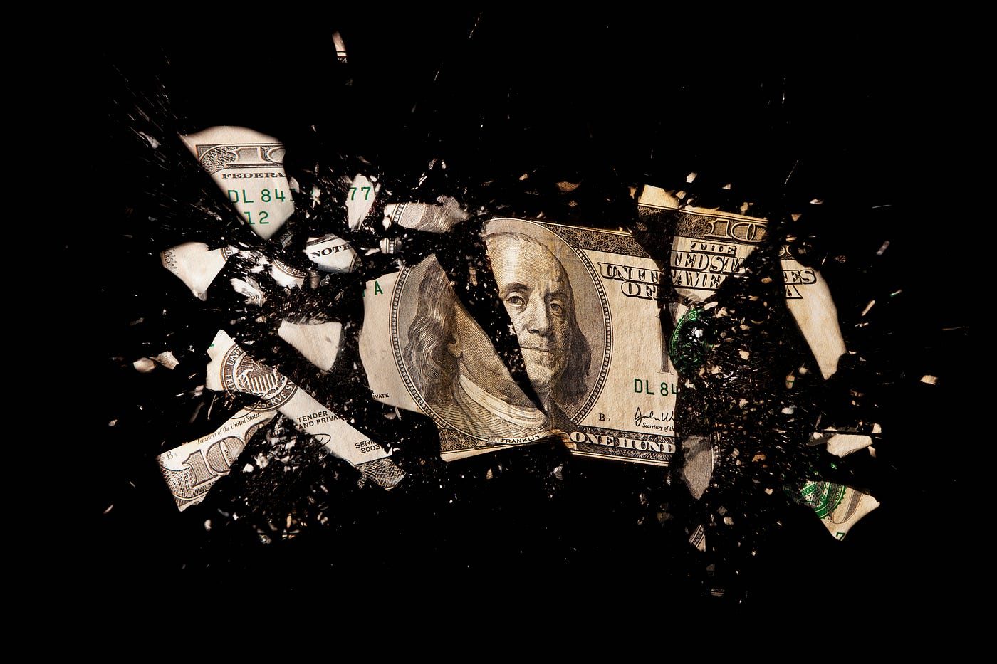 A $100 US dollar bill against a black background.