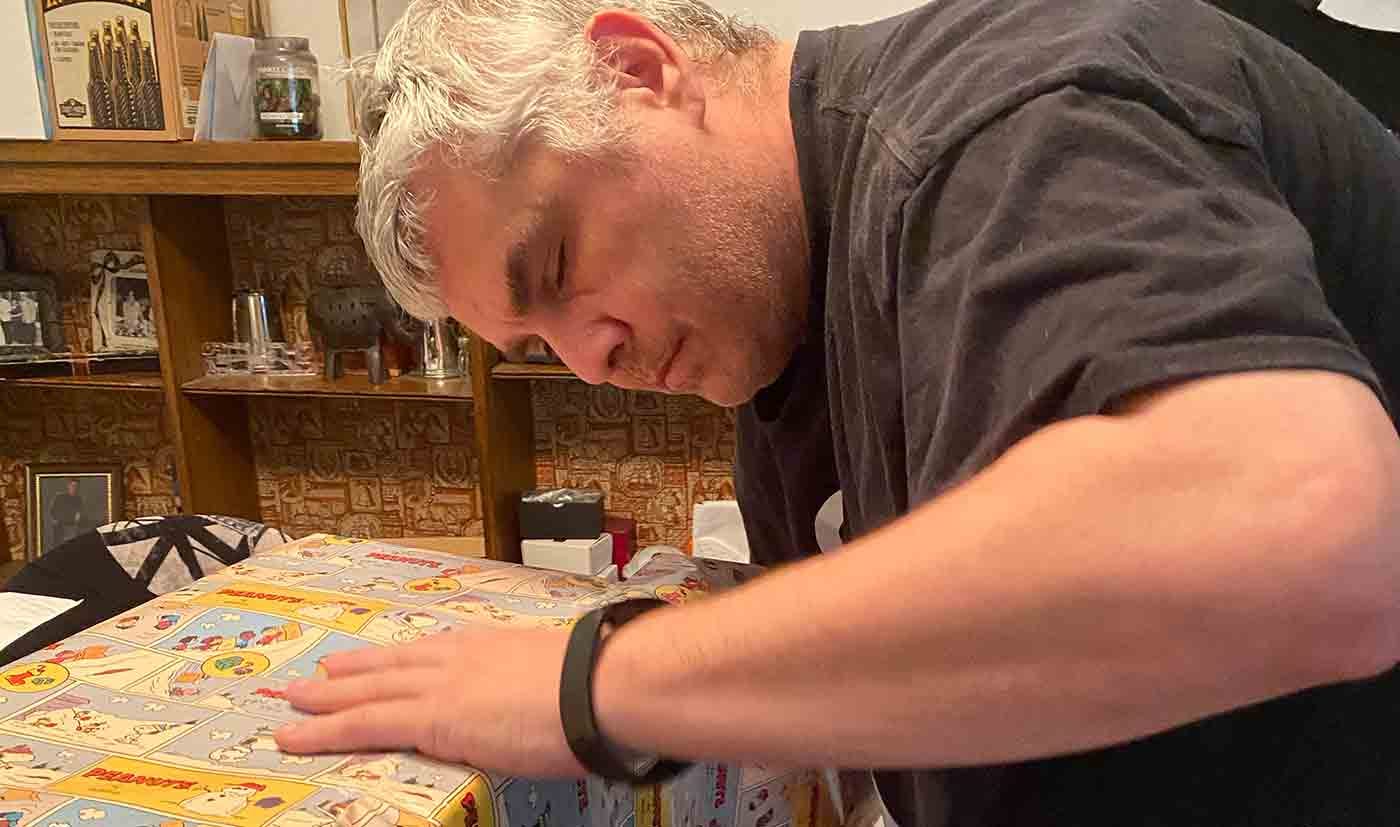 Blind guy Joe Monks wrapping Christmas presents.