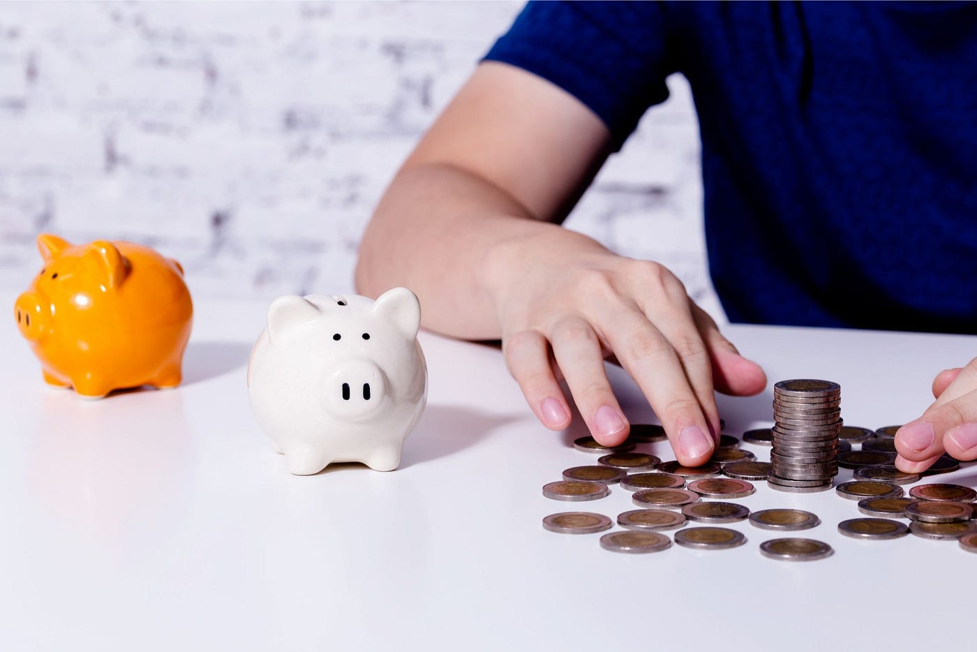 Young man collecting coins and allocating them into categories.