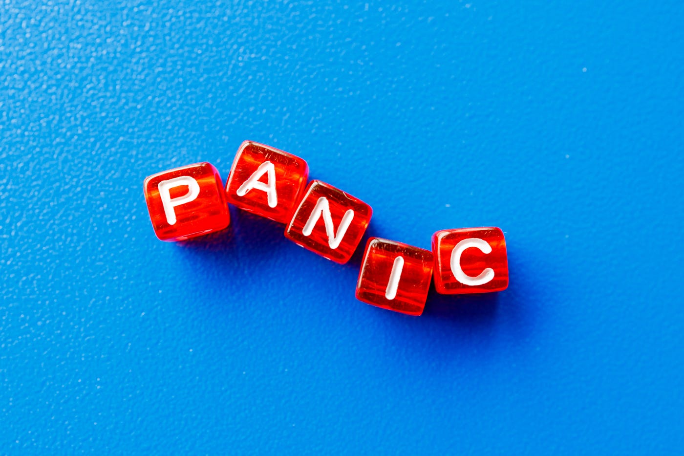 Blue background with red and white letters that read the word panic