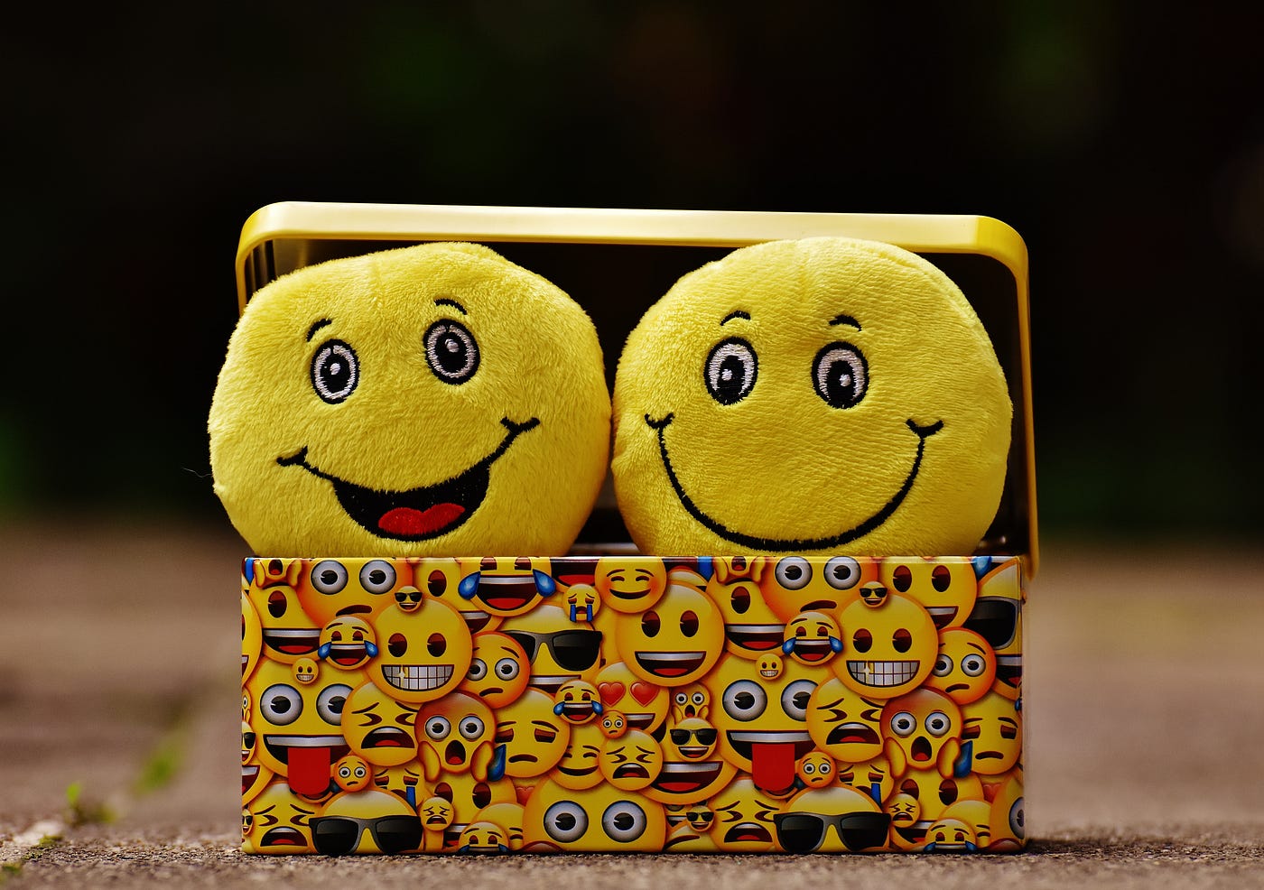 Two happy face pillows in a box