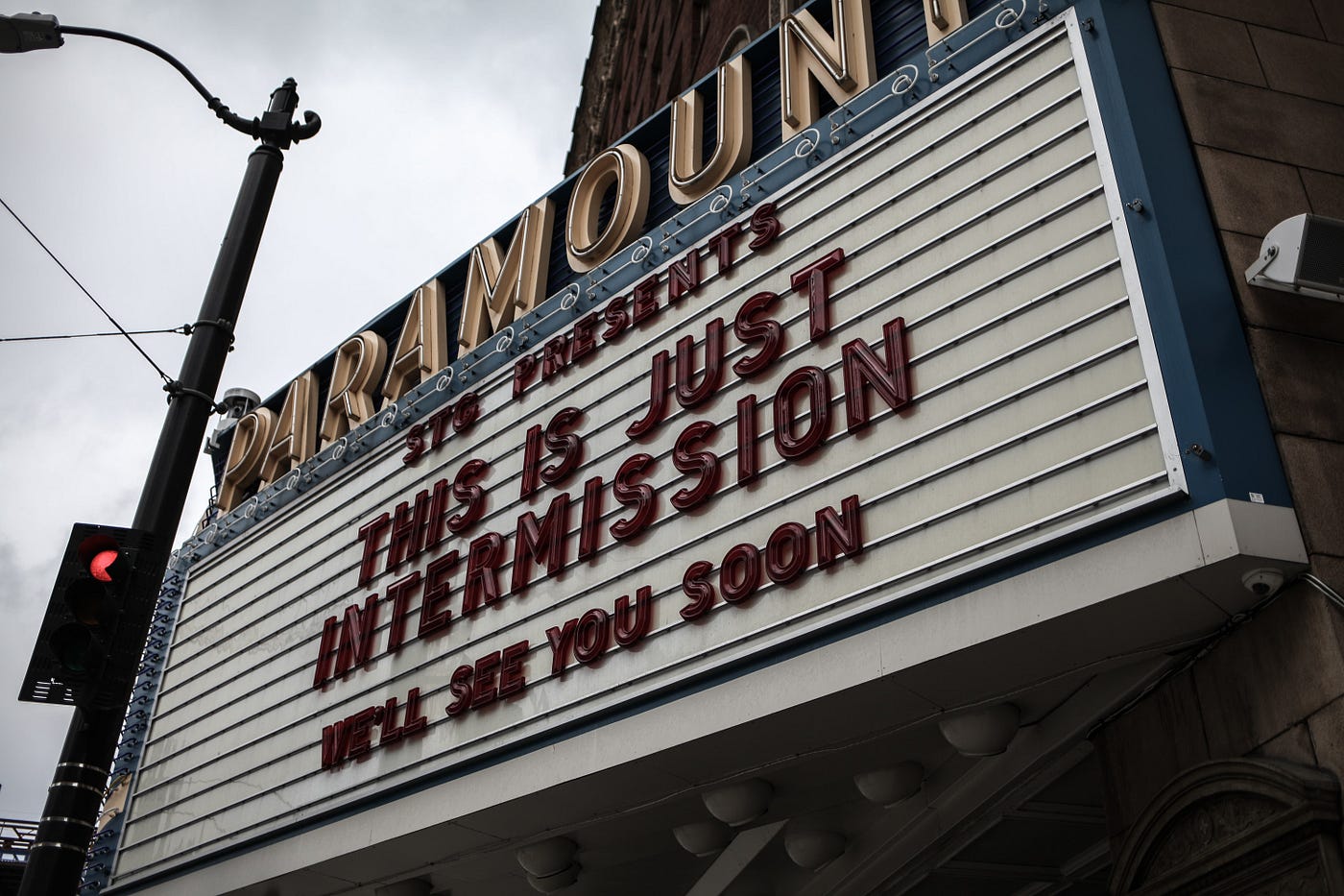 A cinema billboard, with the letters spelling out “STG presents THIS IS JUST INTERMISSION — We’ll see you soon