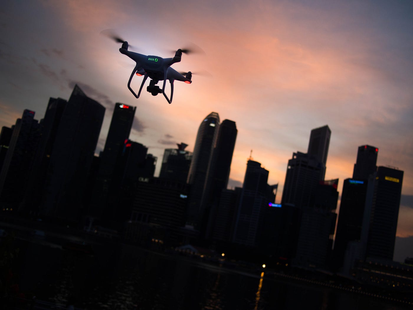 a drone flying above a dark cityscape