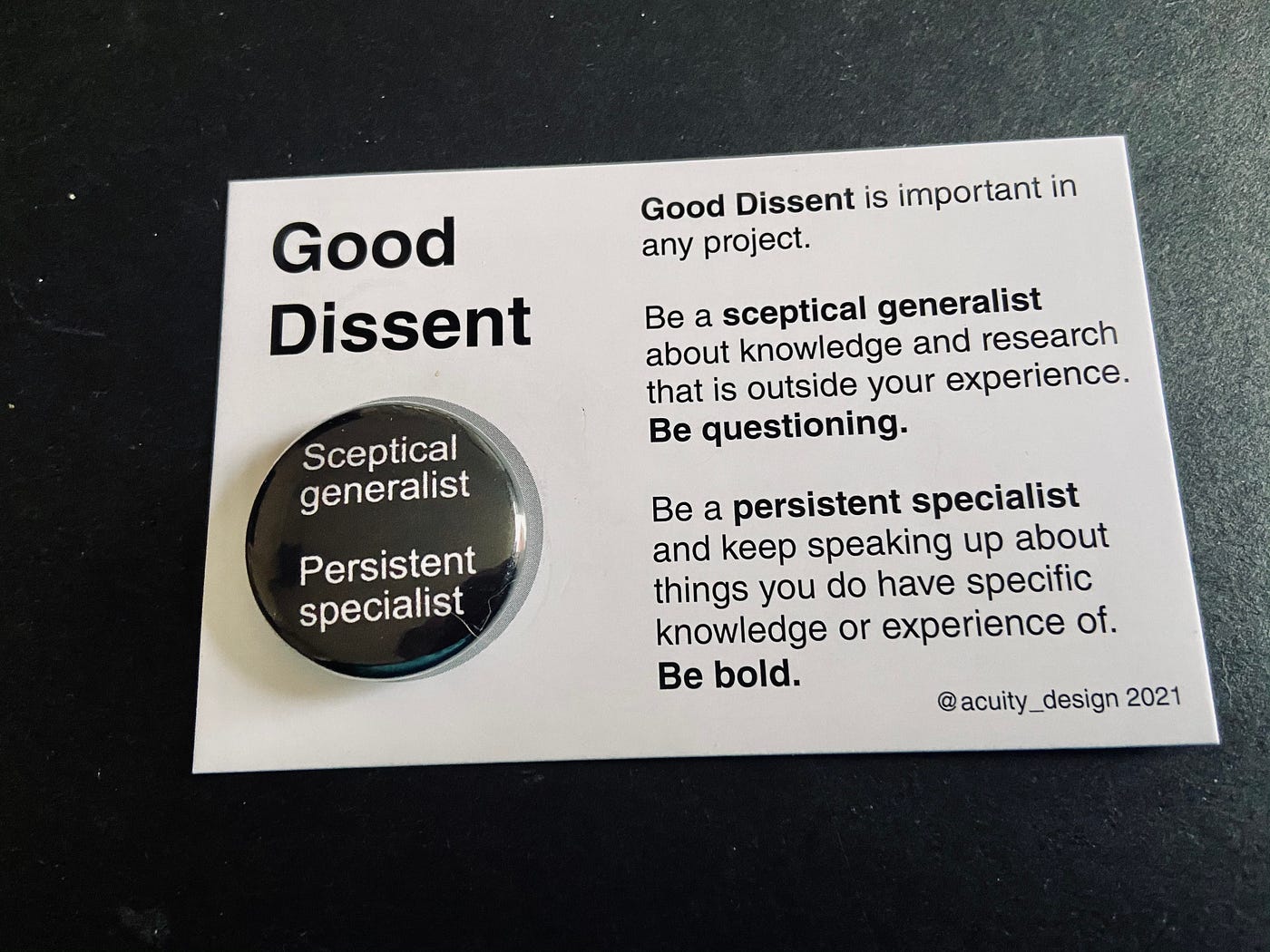 Good Dissent badge on backing card