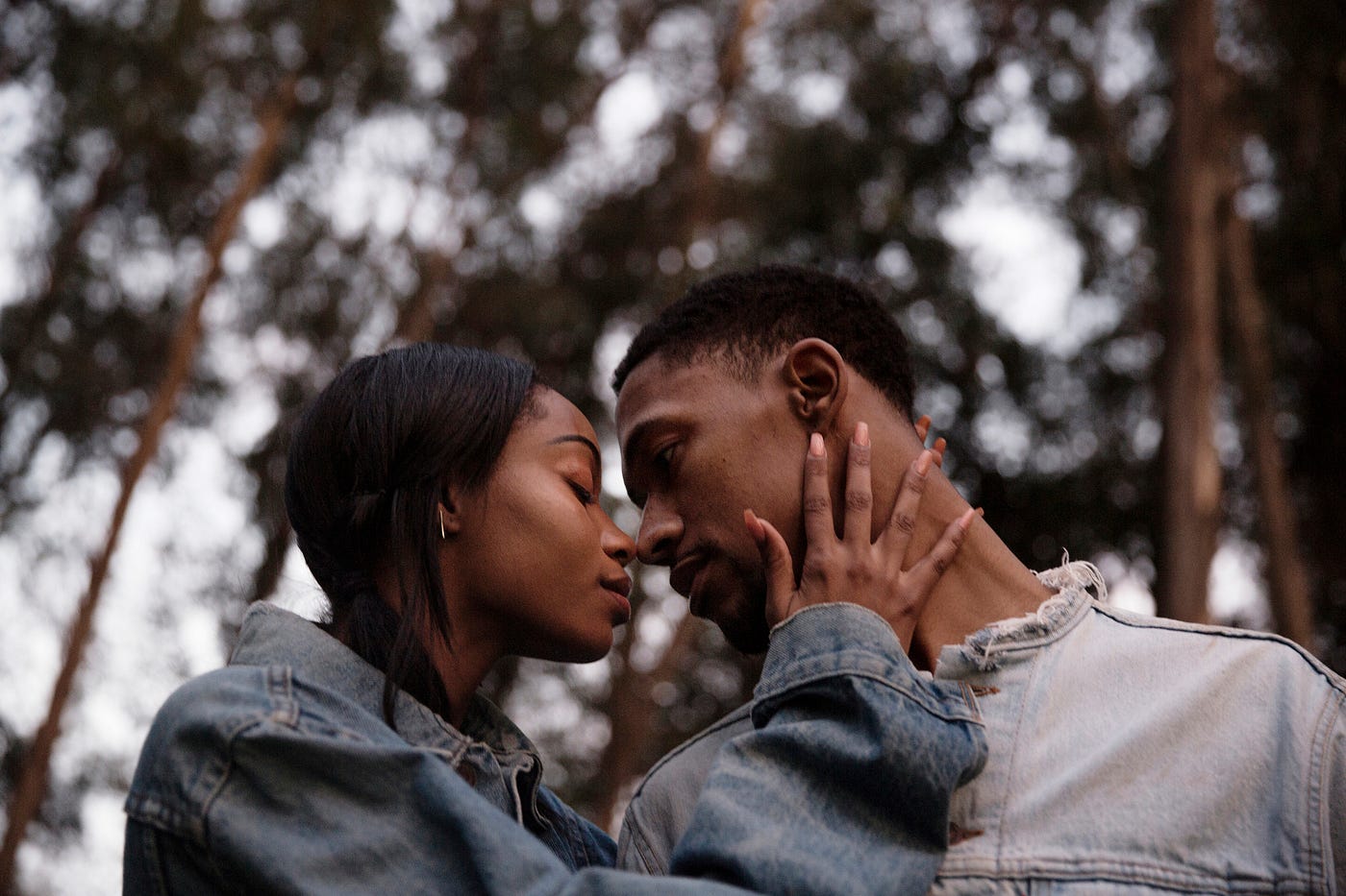 A photo of a black couple about to kiss.