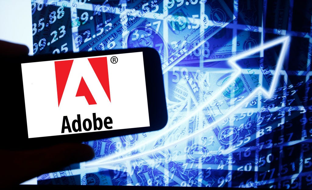 A photo of Adobe’s logo on a smartphone.
