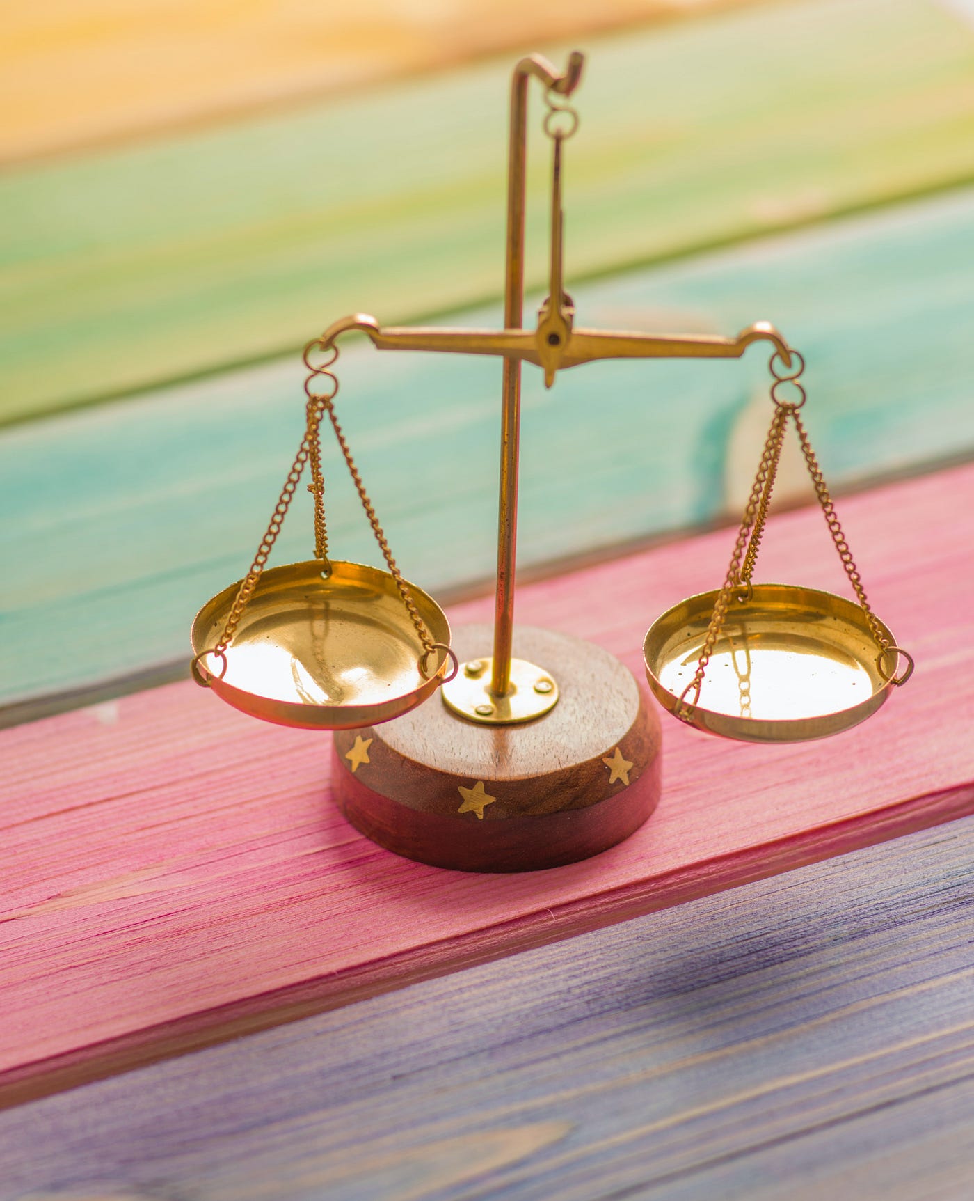a set of scales sitting on a pink board