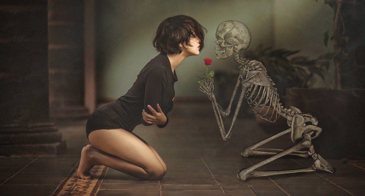 Woman and a skeleton holding a red rose leaning against each other