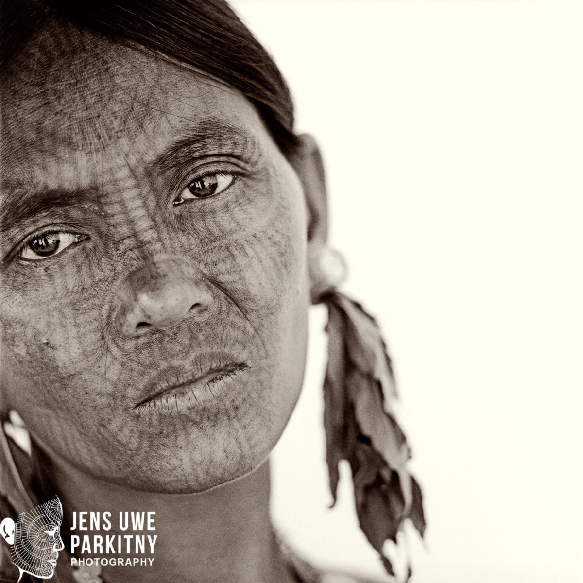 Laytu Chin woman Daw Cue Ma Oo's face is adorned by a very beautiful and complex tattoo pattern, expressing group identity.