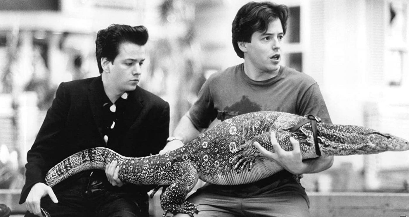 Black and white still of The Freshman, Frank Whaley and Matthew Broderick holding a giant Asian water monitor trying to get it out of a mall