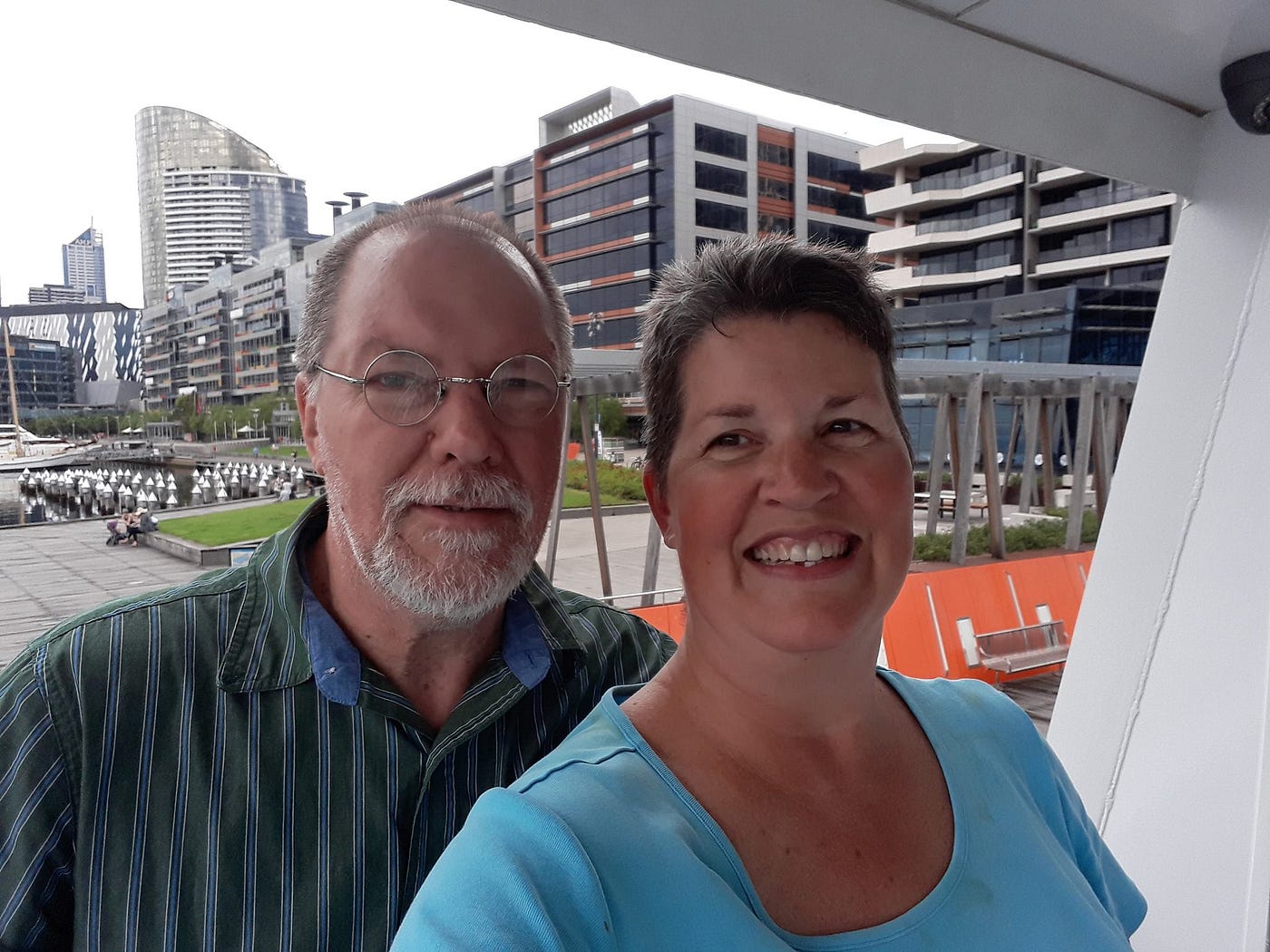 Photo of the author and her partner. The Docklands of Melbourne, Australia are in the background. Photo by Ann Leach.