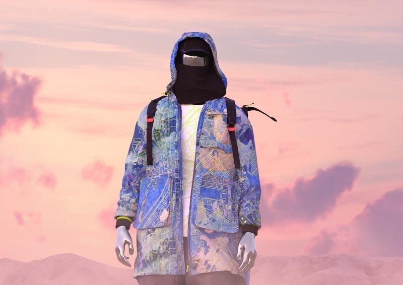 A piece from the Puma x The Fabricant Sustainable Technologies Collection on a faceless model. A sunrise (or sunset) glows pink in the background.