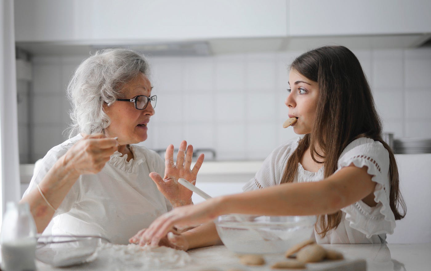 An old and young woman having a conversation in the kitchen
