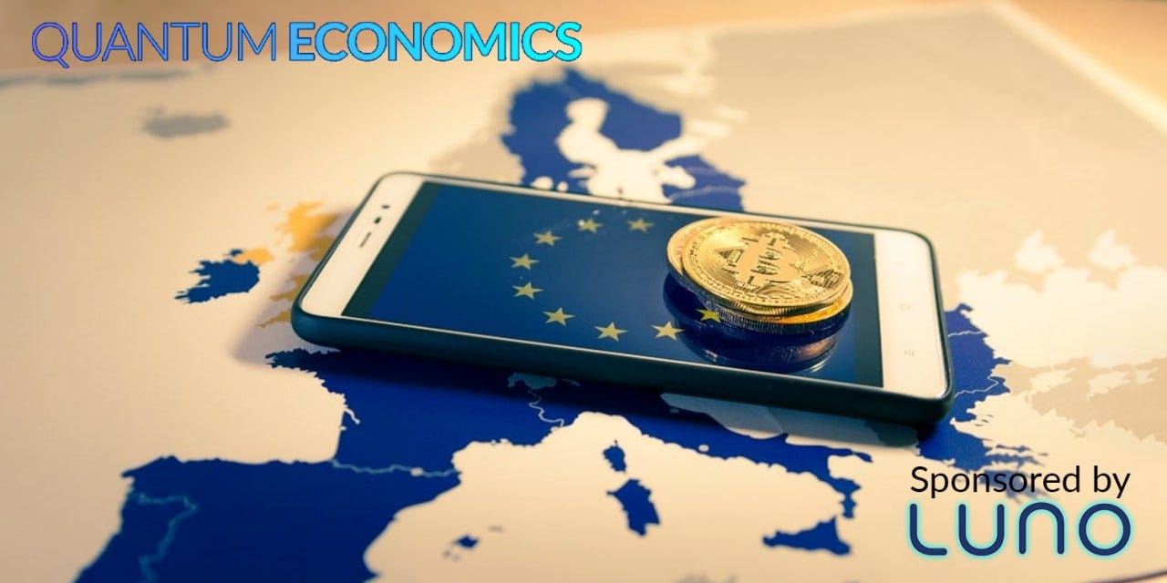 A phone, with units of bitcoin stacked on top of it, which is over a map of Europe.