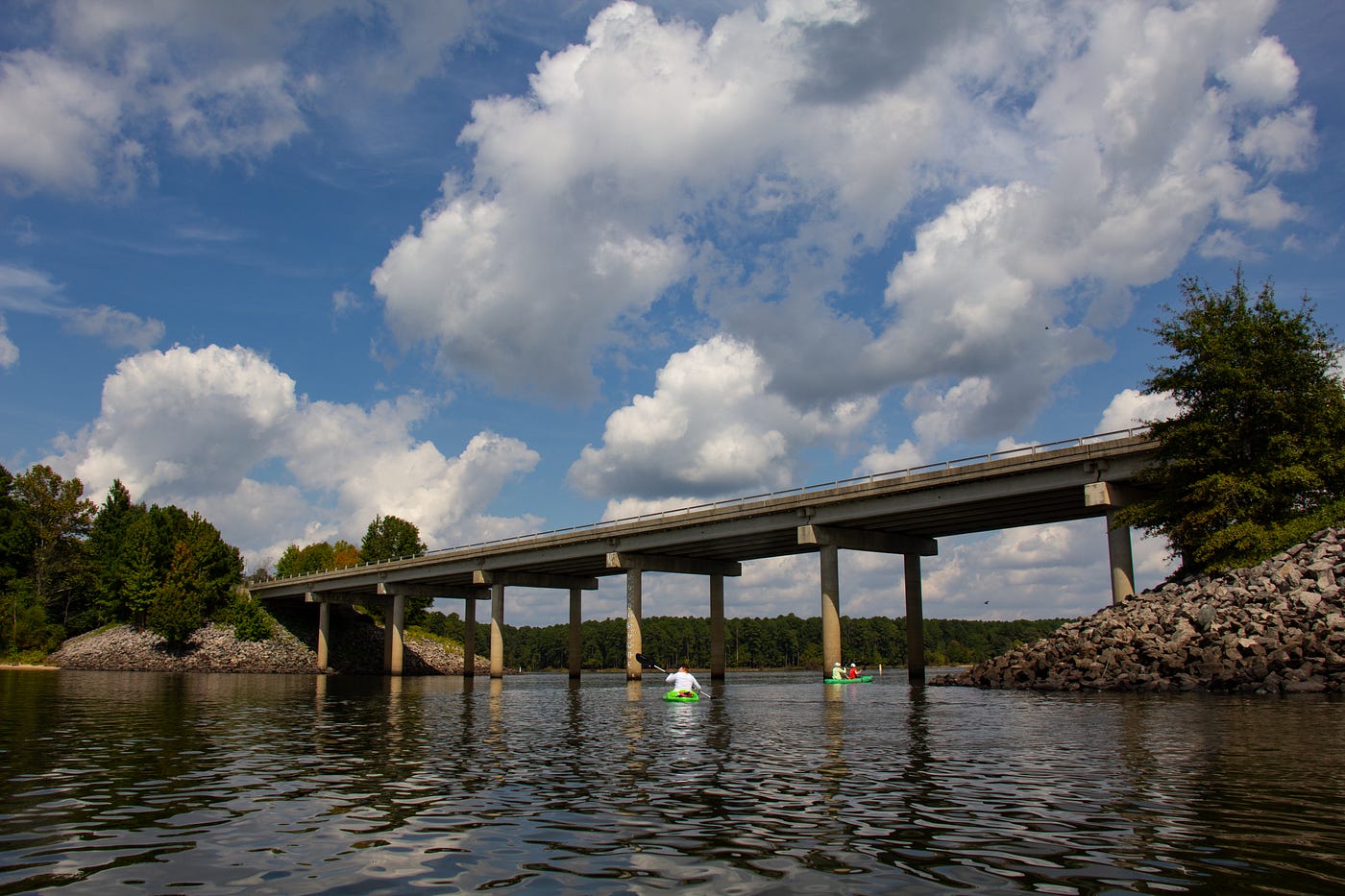 Farrington Road bridge in the foreground, with large clouds across the sky in the background.