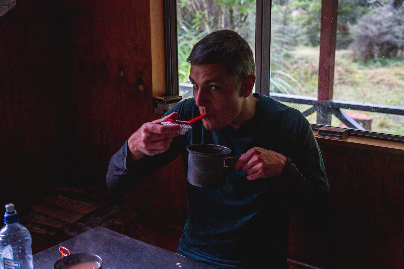 Tramper eating from a pot using the handle of a scrubbing brush