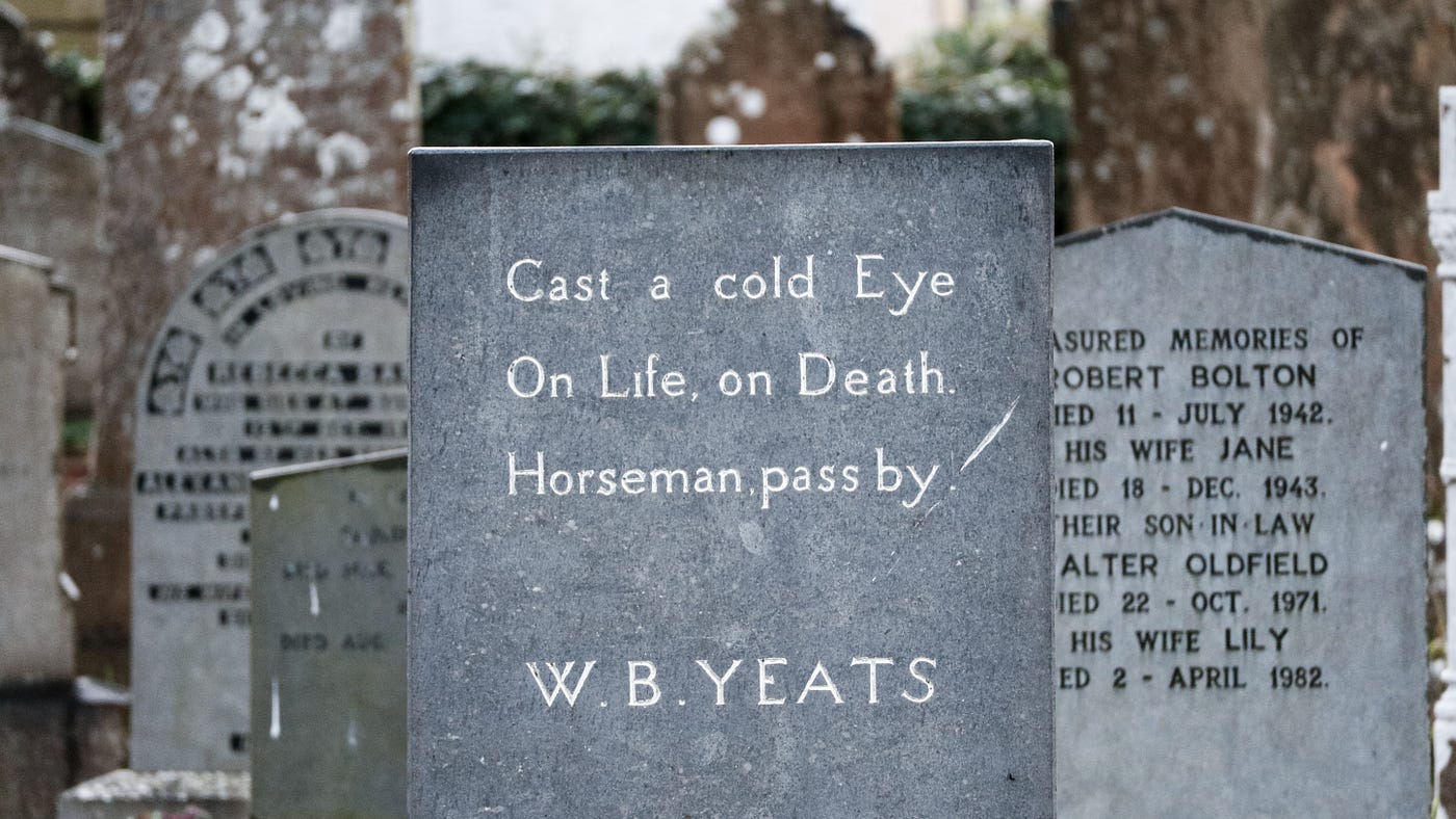 Headstone in a cemetery reads “Cast a cold Eye, On Life On Death. Horseman pass by -W.B. Yeats”