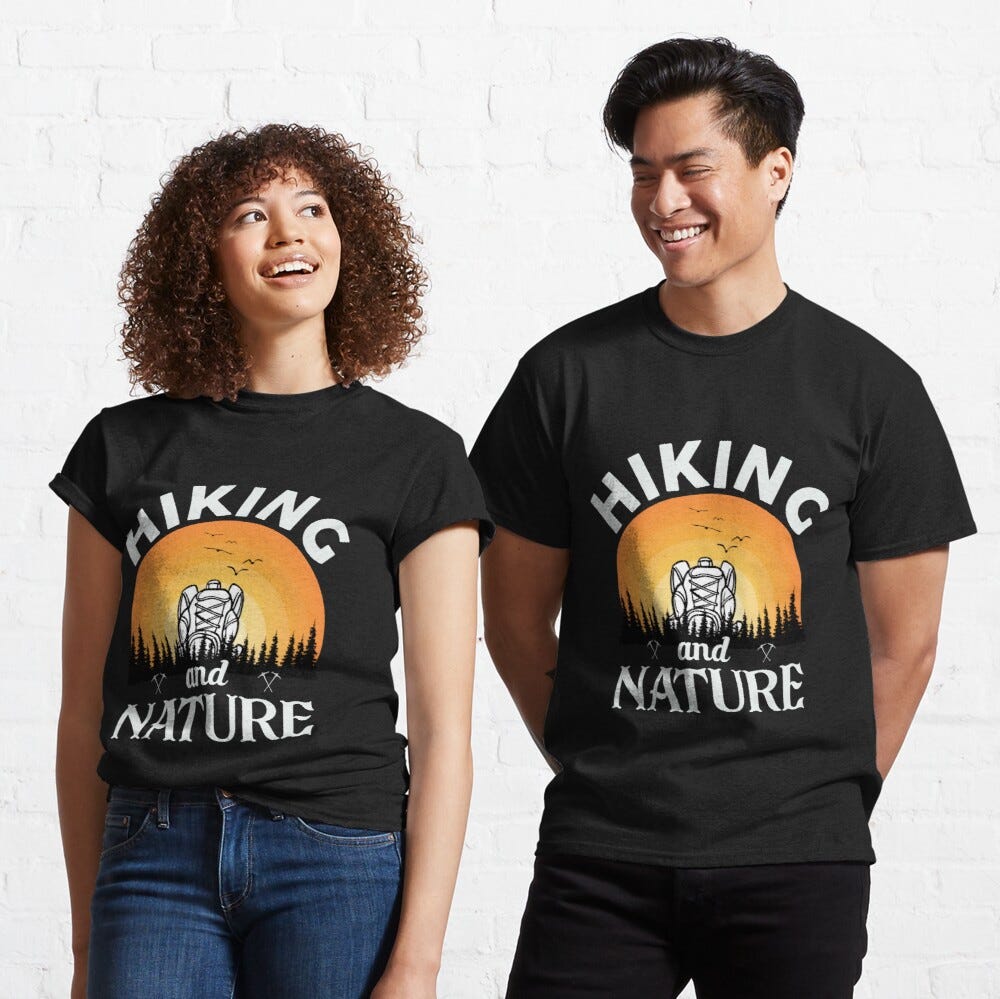 Man and Woman Wearing a black classic t-shirt with amazing illustration and text saying “hiking and nature”.